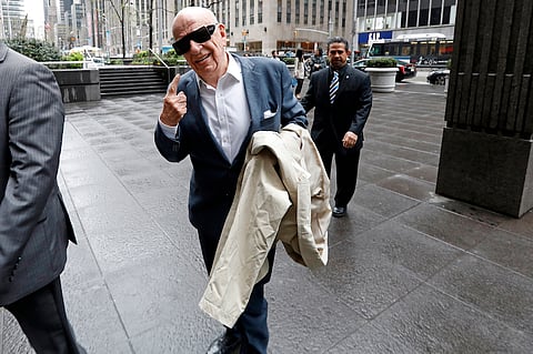 Rupert Murdoch, co-chairman and founder of Twenty-First Century Fox Inc., right, gestures while arriving at the News Corp. building in New York, U.S., on Wednesday, April 26, 2017. The Murdoch family has had to part ways with the star of their profitable Fox News channel after a series of sexual harassment allegations against him, as former Fox News host Andrea Tantaros stepped up her fight with her ex-employer claiming in a new lawsuit that she was a victim of hacking, electronic surveillance and a social media harassment campaign. Photographer: Peter Foley/Bloomberg