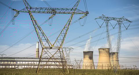 Electricity pylons carry high voltage power lines from the Hendrina power station, operated by Eskom Holdings SOC Ltd., in Middelburg, South Africa on April 13, 2016. Photographer: Waldo Swiegers/Bloomberg