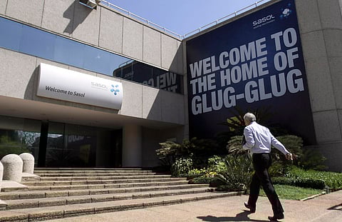 A Sasol Ltd. employee enters the company's headquarters in Johannesburg, South Africa, on Monday. Sept. 13, 2010. Sasol Ltd., the largest producer of motor fuels made from coal, beat analysts' earnings estimates and raised its dividend payment by 24 percent after increasing production and cutting costs. Photographer: Nadine Hutton/Bloomberg