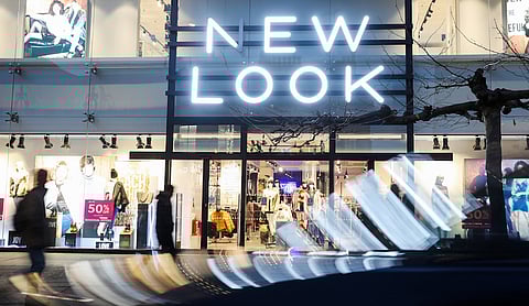 Light reflects from a passing vehicle outside a New Look clothing retail store, owned by Brait SE, in London, U.K., on Tuesday, Dec. 12, 2017. Steinhoff International Holdings NV Chairman Christo Wiese, a major shareholder in Brait, is seeking to stabilize the embattled retailer. Photographer: Luke MacGregor/Bloomberg