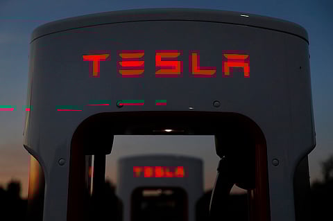 A Tesla Inc. Supercharger station stands illuminated at dusk in Rubigen, Switzerland, on Thursday, Aug. 16, 2018. Tesla chief executive officer Elon Musk has captivated the financial world by blurting out via Twitter his vision of transforming Tesla into a private company. Photographer: Stefan Wermuth/Bloomberg