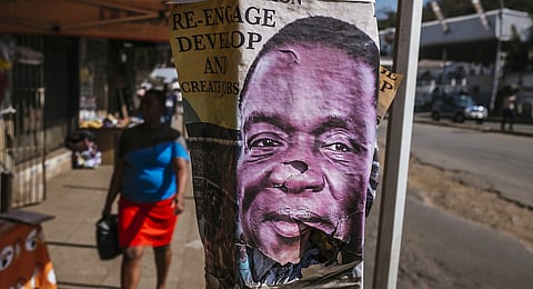 An election poster for Emmerson Mnangagwa, Zimbabwe's president and leader of Zimbabwe African National Union – Patriotic Front (ZANU–PF), sits on a lampost in Harare, Zimbabwe, on Tuesday, July 31, 2018. Zimbabwe's main opposition party said it was well ahead in the first election of the post-Robert Mugabe era and it's ready to form the next government, as unofficial results began streaming in. Photographer: Waldo Swiegers/Bloomberg