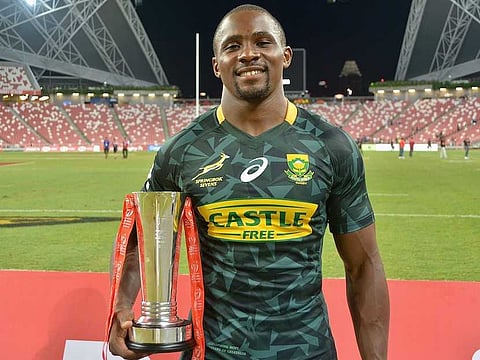 Blitzboks captian Siviwi Soyizwapi with the Singapore Sevens Cup Final trophy.