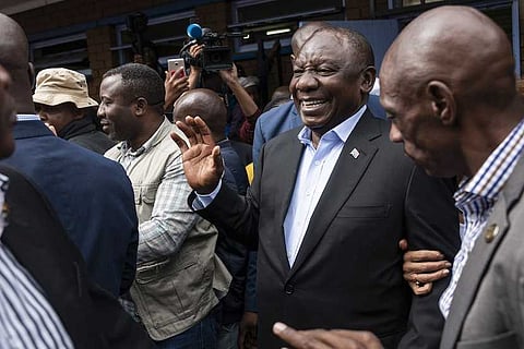 Cyril Ramaphosa, South Africa's president, second right, greets supporters as he arrives to cast his vote at a polling station during the general election in Soweto, South Africa, on Wednesday, May 8, 2019. Photographer: Waldo Swiegers/Bloomberg