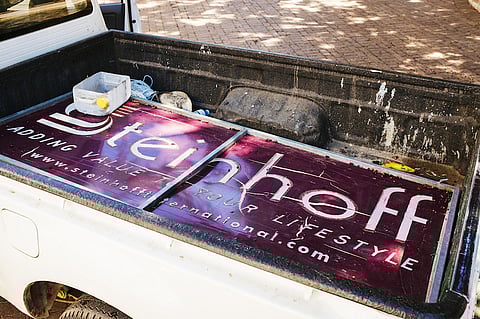 Advertising banners for Steinhoff International Holdings NV sit in a pickup truck after being removed from the University of Stellenbosch sports field in Stellenbosch, South Africa on Friday, Jan. 26, 2017. Markus Jooste, former CEO of Steinhoff International Holdings NV, is at the center of the accounting scandal that’s wiped some $14 billion off the retailer’s market value and roiled the wealthy enclave of Stellenbosch, where many prominent business leaders live, work and play. Photographer: Waldo Swiegers/Bloomberg