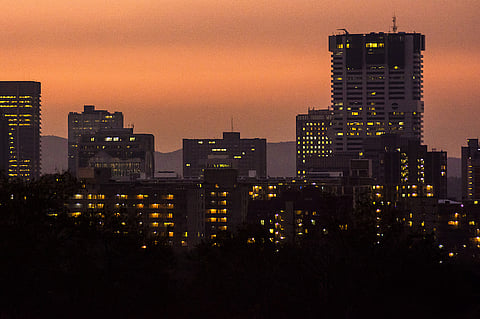 The windows of commercial and residential buildings are illuminated at night in the central business district Pretoria, South Africa, on Saturday, June 1, 2019. While South African President Cyril Ramaphosa says power utility Eskom Holdings SOC Ltd. is considered too big to fail, it could be too big to support because of the costs associated with stabilizing its finances, Engineering News reported, citing S&P Global Ratings Director Ravi Bhatia. Photographer: Waldo Swiegers/Bloomberg