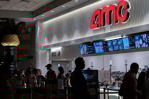 People wearing protective masks visit the concession stand at the AMC Lincoln Square 13 movie theater in New York, U.S., on Thursday, June 10, 2021.  Photographer: Jeenah Moon/Bloomberg