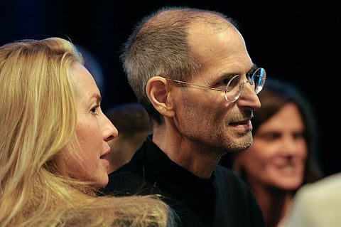 Steve Jobs, chief executive officer of Apple Inc., right, greets members of the audience with his wife Laurene Powell Jobs after unveiling the iCloud storage system at the Apple Worldwide Developers Conference 2011 in San Francisco, California, U.S., on Monday, June 6, 2011. Apple is using iCloud to retain its dominance in the smartphone and tablet markets amid fresh competition from devices powered by Google Inc.'s Android software. Photographer: David Paul Morris/Bloomberg *** Local Caption *** Laurene Powell Jobs; Steve Jobs