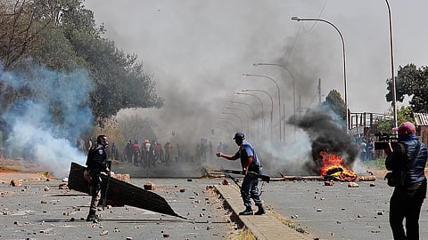 Community members attack Eldorado Park Police Station during a protest on August 27, 2020 in Eldorado Park, South Africa. It is alleged that residents took to the streets after a 16 year old boy was shot and killed by the police. (Photo by Fani Mahuntsi/Gallo Images via Getty Images)
