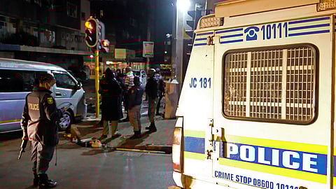 Police and security attend to a looted liquor store during protests in the Central Business District (CBD) on July 11, 2021 in Johannesburg, South Africa. It is reported that the protests  allegedly linked to #FreeZuma in KZN escalated in parts of Johannesburg CBD, with scenes of violent looting, damage to businesses and private property. (Photo by Gallo Images/Dino Lloyd)