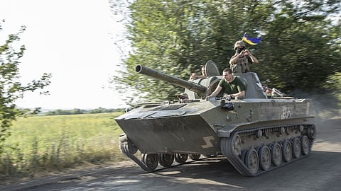 SIVERSK, DONETSK PROVINCE, UKRAINE, JULY 04: Ukrainian serviceman ride on top of a tank towards the battlefield in Siverisk frontline, Ukraine, July 04th, 2022. (Photo by Narciso Contreras/Anadolu Agency via Getty Images)
