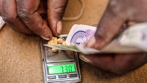 Prisca Muchokore, manager of DT Mining Syndicates, places small balls of mined gold onto a scale to weigh and calculate payment for the artisanal miners at a small-scale gold mine in Umguza, Zimbabwe, on Saturday, Nov. 10, 2018. On January 1, the London Bullion Market Association will introduce a new version of guidelines for the Responsible Gold Guidance program that embrace what’s called environmental, social and governance standards. Photographer: Cynthia R Matonhodze/Bloomberg