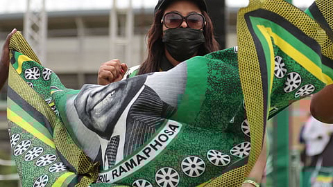 POLOKWANE, SOUTH AFRICA - JANUARY 08: A woman holding a cloth bearing the face of president Cyril Ramaphosa at the ANC 110th anniversary held at the old Peter Mokaba Stadium on January 08, 2022 in Polokwane, South Africa. The ANC was founded on January 08 in 1912. Photo by Gallo Images/Daily Maverick/Felix Dlangamandla)
