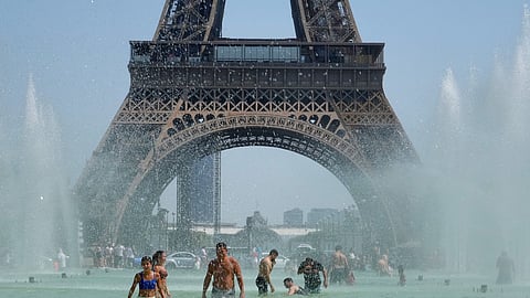 PARIS, FRANCE - JULY 19: Parisians and tourists cool off from the heat by going in the Trocadero Garden Fountain on July 19, 2022 in Paris, France. (Photo by Kevin Mazur/Getty Images)