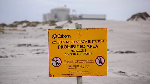 A boundary sign on Melkbosstrand beach outside the Koeberg nuclear power station, operated by Eskom Holdings SOC Ltd., in Cape Town, South Africa, on Wednesday, Nov. 25, 2020. The decision to begin installing new steam generators at the Koeberg plant near Cape Town underscores state-owned Eskom’s confidence that it will win approval to prolong production of low-emissions nuclear power into the middle of the century. Photographer: Dwayne Senior/Bloomberg