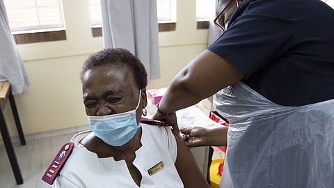 A healthcare worker receives a dose of the Johnson & Johnson vaccine against the COVID-19 coronavirus as South Africa proceeds with its inoculation campaign at the Klerksdorp Hospital Photographer: Phill Magakoe/AFP/Getty Images