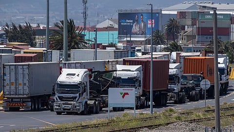 Hundreds of trucks wait in and around Cape Town Harbor to load and unload cargo containers on December 23, 2021 in Cape Town, South Africa. This follows after Transnet declared a force majeure for its activities after a prolonged power outage in Cape Harbor. (Photo by Gallo Images/Die Burger/Jaco Marais)