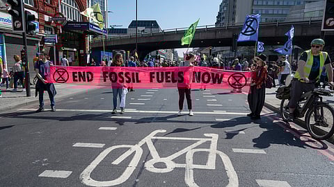 Extinction Rebellion protesters demonstrate to draw attention to the climate emergency and the need to end use of fossil fuels on April 16th 2022 in London, United Kingdom. (Photo by Jenny Matthews/In Pictures via Getty Images)