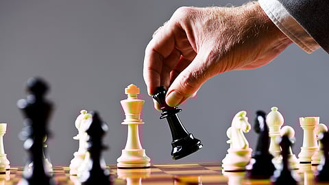 Moments before checkmate, a businessman's hand moves his queen. Chess makes for wonderful metaphors and there are lots here, including the war between the sexes. Shot with Canon EOS 1Ds Mark III.
