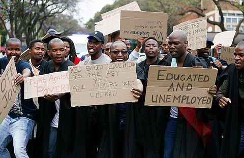 PRETORIA, SOUTH AFRICA – NOVEMBER 06: Unemployed graduates from Kwa-Zulu Natal and Pretoria march to the Union Buildings on November 06, 2018 in Pretoria, South Africa. The graduates, some wearing their graduation regalia possess qualifications ranging from economics degrees, fine arts diplomas and teaching diplomas handed over a memorandum to officials demanding government to come up with solutions to tackle the rising unemployment rate. (Photo by Gallo Images / Phill Magakoe)