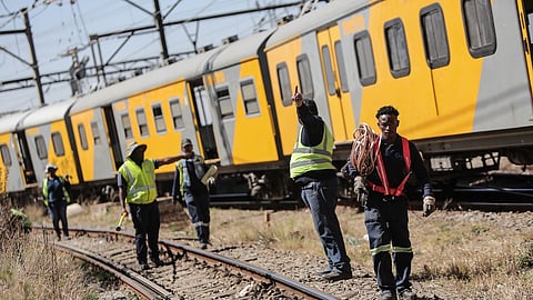 Metrorail employees work on the scene where two trains collided in Selby on September 04, 2018 in Johannesburg, South Africa. Preliminary investigations reveal that human error could be behind the head-on collision of two Metrorail trains that left more than 100 people injured in south of Johannesburg. (Photo by Gallo Images / Sowetan / Alaister Russell)