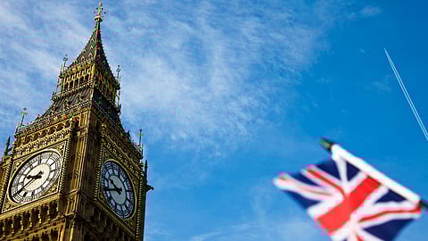 landmarks of London/United Kingdom flag and aircraft condensation trails,