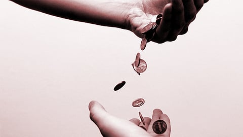 Money falling from one hand to another.