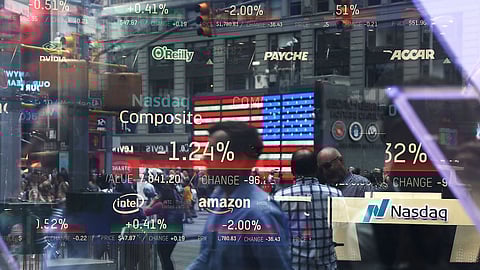 People are reflected in the window of the Nasdaq MarketSite in Times Square on July 30, 2018 in New York City. As technology stocks continued their slide on Monday, the Nasdaq Composite dropped 1.1 percent in afternoon trading with shares of Facebook, Netflix, Amazon and Google-parent Alphabet all declining. (Photo by Spencer Platt/Getty Images)