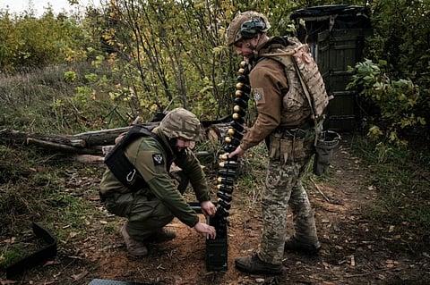 Soldiers of Ukraine's 5th Regiment of Assault Infantry put ammunition into a crate before setting a US-made MK-19 automatic grenade launcher towards Russian positions in less than 800 metres away at a front line near Toretsk in the Donetsk region on October 12. Photographer: Yasuyoshi Chiba/AFP/Getty Images