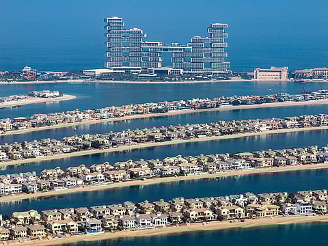 Residential villas on the waterside of the Palm Jumeirah, backdropped by the Atlantis Royal Residences and resort on Palm Jumeirah in Dubai, United Arab Emirates, on Wednesday, Sept. 28, 2022. Photographer: Christopher Pike/Bloomberg