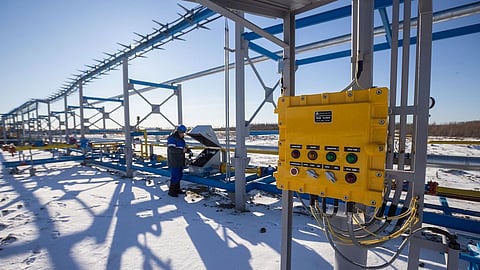 A worker checks the horizontal flare system by a gas well at the Gazprom PJSC Chayandinskoye oil, gas and condensate field, a resource base for the Power of Siberia gas pipeline, in the Lensk district of the Sakha Republic, Russia, on Tuesday, Oct. 12, 2021. European natural gas futures declined after Russia signaled that it may offer additional volumes soon.