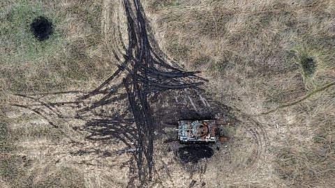 Artillery and mortar craters pierce the ground next to a destroyed Russian tank, on October 23, 2022 in Kam'yanka, Kharkiv oblast, Ukraine. Ukraine's president Volodymyr Zelensky has accused Russia of launching a massive attack on his country's energy grid causing around 1.5 million households to be left without electricity. (Photo by Carl Court/Getty Images)