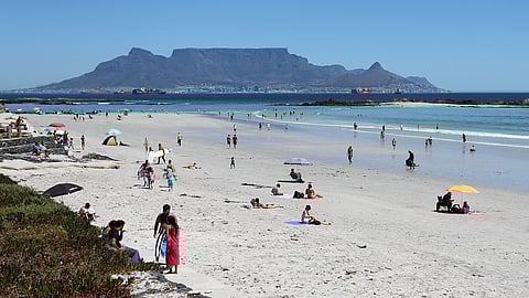 CAPE TOWN, SOUTH AFRICA - FEBRUARY 02: People return to the beach and enjoy a hot summers day at Big Bay on February 02, 2021 in Cape Town, South Africa. It is reported that the government has eased the current lockdown restrictions and public places like beaches, dams, rivers, parks and public swimming pools will be reopened. (Photo by Gallo Images/Shaun Roy)