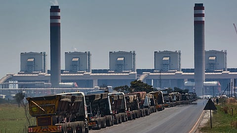 Coal delivery trucks queue outside the Eskom Holdings SOC Ltd. Kusile coal-fired power station in Mpumalanga, South Africa, on Friday, Oct. 15, 2021. Envoys from some of the world’s richest nations met with South African cabinet ministers to discuss a climate deal that could channel almost $5 billion toward ending the country’s dependence on coal. Photographer: Waldo Swiegers/Bloomberg