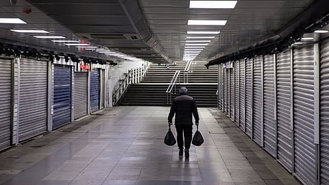 A pedestrian passes retail stores closed to prevent the spread of coronavirus in the Eminonu district of Istanbul, Turkey, on Wednesday, March 25, 2020. Turkish manufacturers confidence in the economy has plunged the most since the 2008 global financial crisis, the first key piece of data reflecting the coronaviruss toll on local businesses. Photographer: Kerem Uzel/Bloomberg