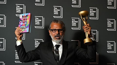 Shehan Karunatilaka lofts the trophy and his second novel, The Seven Moons of Maali Almeidad, on winning the 2022 Booker Prize at London’s Roundhouse on Oct. 17.