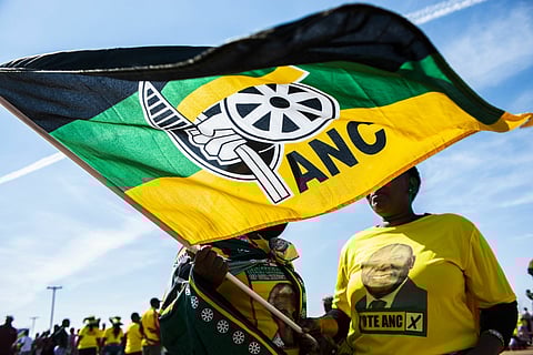 Supporters wearing party colors wave a flag during an African National Congress party (ANC) campaign event in Bloemfontein, South Africa, on Sunday, April 7, 2019. The ANC is expected to easily maintain its monopoly on power in the May 8 national elections, albeit with a slightly reduced majority. Photographer: Waldo Swiegers/Bloomberg