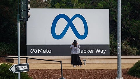 A visitor takes photographs of Meta Platforms signage outside the company's headquarters in Menlo Park, California, U.S., on Friday, Oct. 29, 2021. Facebook Inc. is re-christening itself Meta Platforms Inc., decoupling its corporate identity from the eponymous social network mired in toxic content, and highlighting a shift to an emerging computing platform focused on virtual reality.