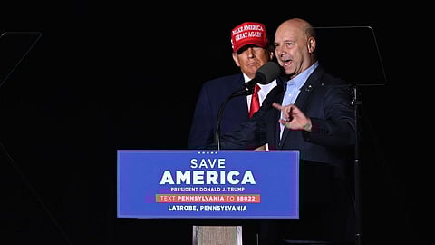 Doug Mastriano, Republican gubernatorial candidate for Pennsylvania, shares the stage with Former US President Donald Trump as he speaks to supporters during a campaign rally in Latrobe, Pennsylvania, US, on Saturday, Nov. 5, 2022. Republican Senate candidate Mehmet Oz has taken the lead in the US Senate race in Pennsylvania against Lieutenant Governor John Fetterman in the final days before Tuesday’s vote, according to a poll released Thursday. Photographer: Dustin Franz/Bloomberg