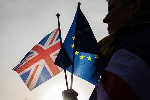 A Pro Europa supporter holds European Union (EU) and a British Union flags during a gathering by the cross party Pro-EU anti-Brexit group in Brussels, Belgium, on Thursday, Jan. 30, 2020. The European Parliament approved Prime Minister Boris Johnsons Brexit deal, clearing the way for the U.K. to leave the EU on Jan. 31 with an agreement that, for the time being, will avoid a chaotic rupture. Photographer: Geert Vanden Wijngaert/Bloomberg