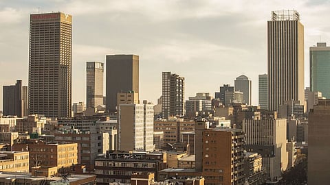 Commercial properties, residential buildings and skyscraper offices on the skyline viewed from a rooftop bar in Johannesburg, South Africa, on Thursday, May 21, 2021. Traders raised bets that South Africa’s central bank will tighten policy this year after inflation accelerated more than expected, resulting in a negative real interest rate for the first time in more than five years. Photographer: Guillem Sartorio/Bloomberg