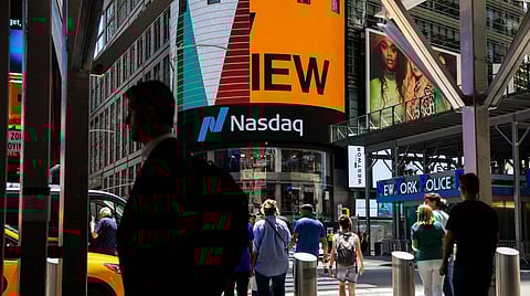 Pedestrians in front of the Nasdaq MarketSite in New York, US, on Wednesday, June 15, 2022. Stocks climbed, Treasury yields tumbled and the dollar pushed lower after Federal Reserve Chair Jerome Powell signaled outsized rate hikes will be rare as officials intensify their battle against rampant inflation. Photographer: Michael Nagle/Bloomberg
