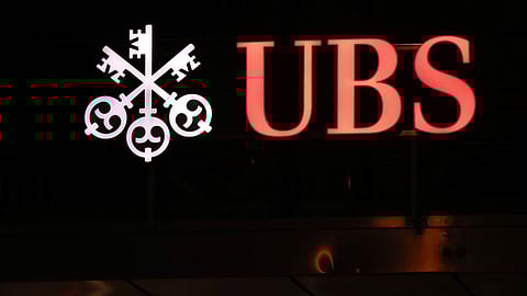 The UBS Group AG logo outside the company's headquarters in Zurich, Switzerland, on Tuesday, Jan. 26, 2021. UBS plans to buy back as much as 4 billion francs ($4.5 billion) of shares over the next three years, bolstering shareholder returns after income from managing client assets and investment banking propelled gains at the world’s largest wealth manager. Photographer: Stefan Wermuth/Bloomberg