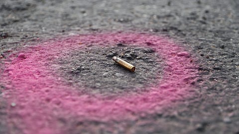 A spent casing highlighted by the police at a crime scene in Feb 2022 on the outskirts of Johannesburg, South Africa. Photographer: Guillem Sartorio/AFP/Getty Images