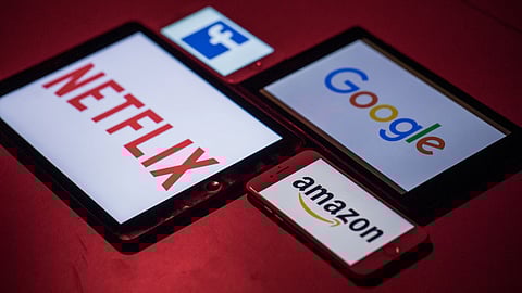 The logos for Facebook Inc., Amazon.com Inc., Netflix Inc. and Google, a unit of Alphabet Inc., sit on smartphone and tablet devices in this arranged photograph in London, U.K., on Monday, Aug. 20, 2018. The NYSE FANG+ Index is an equal-dollar weighted index designed to represent a segment of the technology and consumer discretionary sectors consisting of highly-traded growth stocks of technology and tech-enabled companies. Photographer: Jason Alden/Bloomberg