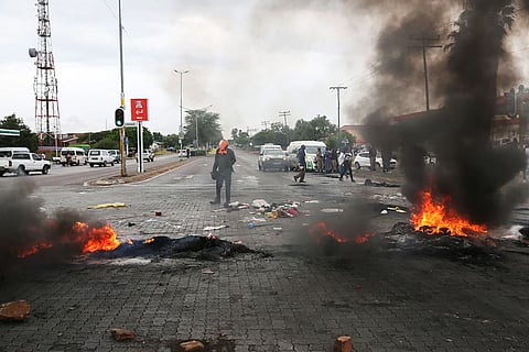 A protest against ongoing water and electricity outages for long periods of time in Soshanguve township, north of Pretoria, on Feb. 1. Photographer: Dinky Mkhize/AFP/Getty Images