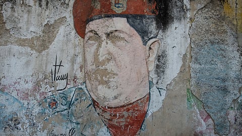 A faded mural of the late Venezuelan President Hugo Chavez in the 23 de Enero district of Caracas, Venezuela, on Tuesday, June 7, 2022. Venezuela's attempt to modernize by moving from Socialism to more capitalistic policies is showing up in many forms, from the widespread use of US dollars to the imported, gourmet foods filling store shelves. But few are as noticeable as the makeover taking place in public spaces once littered with Chavista propaganda. Photographer: Gaby Oraa/Bloomberg