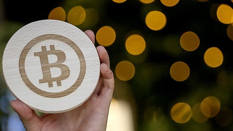 The logo of bitcoin engraved on a piece of wood in Arnhem, Netherlands, on Thursday, Nov. 10, 2022.
