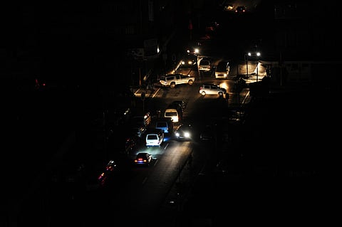 Vehicles on a street without lighting during a loadshedding power outage in Johannesburg. Photographer: Leon Sadiki/Bloomberg