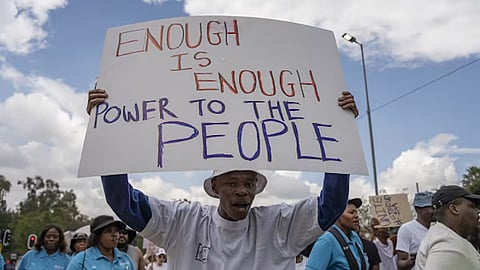 Protestors take to the streets in Johannesburg, South Africa against extended power cuts. Photo by Ihsaan Haffejee/Anadolu Agency via Getty Images